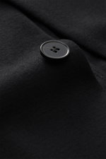 Alt tag (124 characters):
Close-up from above of a black button on Harris Wharf London Jersey jacket black made of soft, lightweight virgin wool fabric.

Description:
<p>The elegant look of a smart-casual jacket meets the comfort of a sweat jacket – HARRI