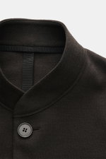 Close-up front view of Harris Wharf London Jersey jacket dark brown showing standing collar, four-button style, and soft virgin wool fabric. 

Description: The elegant look of a smart-casual jacket meets the comfort of a sweat jacket – HARRIS WHARF LONDON