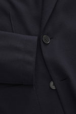 Close-up front view of Harris Wharf London Jersey blazer navy, showcasing the double-breasted two-button style, notched lapel, patch hip pockets, and soft virgin wool jersey fabric in slim fit, unconstructed design with two inner pockets.