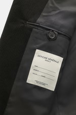 Nahaufnahme des Innenfutters vom Officine Générale Cordsakko 'Michel' schwarz mit Baumwoll-Cord außen und Details wie Kissing Buttons und Innentaschen.