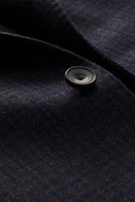 Close-up front-side view of the Santaniello Blazer navy/dark brown checked showing pure wool fabric with soft touch and a dark button. Always well dressed: This elegant blazer from SANTANIELLO made of pure wool with a subtle check pattern reliably accompa