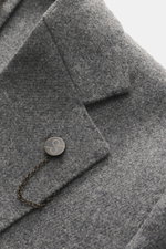 Close-up top-down view of the Santaniello Blazer grey melange lapel and button, showing pure wool slim fit fabric texture and soft touch.