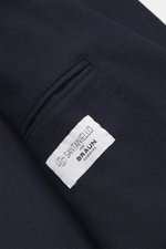 Close-up of the Santaniello Blazer navy fabric and label, photographed from above showing pure wool, soft touch, slim fit with tailored two-button style, notched lapel with label pin, classic breast pocket, patch hip pockets, kissing buttons, rear side ve