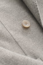 Santaniello Blazer grey/offwhite striped close-up from above showing fine wool fabric with cashmere, button, and detailed texture. Classically elegant into the new season: This double-breasted blazer by SANTANIELLO made of fine wool with cashmere is a pra