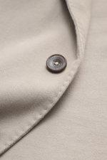 Close-up front angle of the Santaniello Taupe Blazer showing button and soft cotton twill fabric, slim fit, lightly elastic, unconstructed.