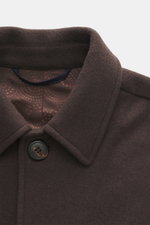 Close-up front-top view of the Doppiaa Jacket 'Aarneis' dark brown showing turn-down collar, five-button placket, doubleface jersey made of cashmere, virgin wool, and microfiber, very soft feel, regular fit, slanted welt pockets, sleeve cuffs with button 