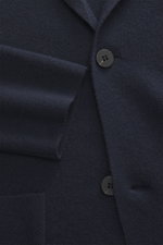 Close-up view of the navy von Braun Cashmere knit blazer showing fine knit texture, two-button front, and patch hip pocket, slim fit, pure cashmere.