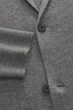 Close-up front view of the von Braun Cashmere knit blazer grey showing fine knit texture, two-button style, and patch hip pockets, made of pure cashmere with a very soft touch, slim fit, unlined combining classic tailoring and jumper softness.