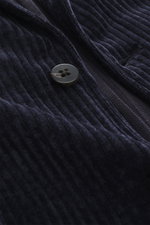 Close-up front view of the button and ribbed cord fabric of the 04651/ A trip in a bag Cord Blazer navy, made of high-quality microfiber, light elastic quality, slim fit, tailored two-button style, notched lapel, patch hip pockets, small woven label in th