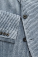 Close-up front view of 04651/ A trip in a bag Cord Blazer Smoke Blue showing cord microfiber fabric, slim fit, tailored two-button style, notched lapel, patch hip pockets, small woven label in side seam, rear side vents, sleeve cuffs with buttons, unconst