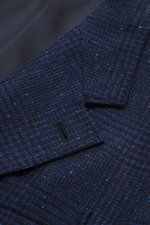 Brunello Cucinelli Navy/grey-blue checked blazer close-up from above, showing wool with cashmere, soft touch, Prince-of-Wales, Slim Fit, three-button, notch lapel, breast pocket, hip flap pockets, ticket pocket, sleeve cuffs with buttons, rear side vents,