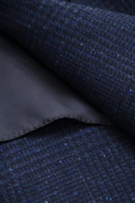 Close-up view of Brunello Cucinelli Navy/grey-blue checked blazer fabric showing wool with cashmere, soft touch, Prince-of-Wales pattern.