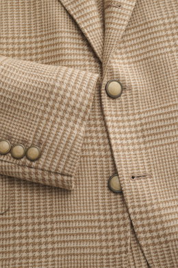 Close-up front view of Brunello Cucinelli Beige/light brown checked blazer showing Prince of Wales check pattern, slim fit, three-button style, notched lapel, classic breast pocket, hip pockets with flaps, small ticket pocket, sleeve cuffs with buttons; m
