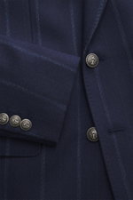 Close-up front view of Brunello Cucinelli Navy striped blazer in virgin wool and cashmere blend, soft touch, slim fit, double-breasted three-button style with peak lapels, classic breast pocket, hip pockets with flap, small ticket pocket, unfinished sleev