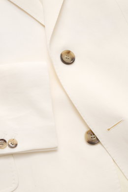 A close-up front view of the Ami Paris Smart-casual jacket cream showing the slim-fit cream viscose-linen blend fabric with a step lapel, two-button style, classic breast pocket, hip flap pocket, and buttoned cuffs. Versatility for summer: This smart-casu