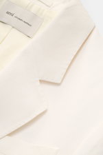 Close-up top-down view of Ami Paris Smart-casual jacket cream collar and label, showing viscose-linen blend fabric texture.

<p>Versatility for summer: This smart-casual jacket by AMI PARIS combines a classic cut with practical pockets and a casual attitu