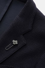 Close-up front angled view of Lardini Knitted Blazer Navy, knit from wool with a soft touch, slim fit, draped lapel with flower pin, tailored two-button style, classic breast pocket, patch hip pockets, unfinished sleeve cuffs, rear side vents, unconstruct