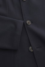 Close-up front view of the Emporio Armani Strickblazer navy showcasing two-button style, tonal herringbone knit, and unconstructed design.