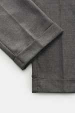 Nahaufnahme der Beinabschlüsse der 04651/ A trip in a bag Wollhose 'Flannel Pants' grau meliert aus Flanell mit kurzem, fixiertem Saumaufschlag, schmal zulaufend.