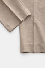 Close-up image from above showing the ankle-length hem of PT Torino Wool trousers 'The Rebel' beige mottled, made of slightly elasticated, smooth virgin wool fabric with a fixed hem turn-up. The Rebel from trouser experts PT TORINO is guaranteed to be you