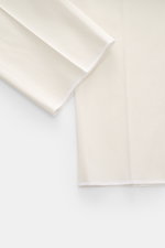 Close-up of the hem and lower leg area of PT Torino Chinos 'Union Fit' cream, photographed from the front left side, showing the open length and soft twill cotton-silk blend fabric with slight stretch for extra freedom of movement, regular fit, tapered cu