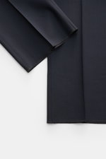 Close-up top-down view of navy PT Torino Wool trousers 'Gentleman Fit' showing the lightweight Super 130'S virgin wool fabric with tapered cut and open length hems. 

Description: For the exclusive trousers 'Gentleman Fit', PT TORINO has chosen virgin woo