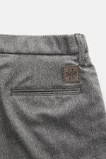 Gray Mélange wool fabric close-up of back pocket and leather logo patch, photographed from above; Jacob Cohen Wool Pants 'Jannik' feature slim fit, slightly elastic wool, soft feel, tapered slim cut, zipper and waistband button, elastic waistband inserts,