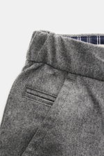 Close-up top-side view of Jacob Cohen Wool Pants 'Jannik' Gray Mélange showcasing slightly elastic wool, slim fit, elastic waistband inserts, french pockets, piped coin and back pockets, zipper, button, and small calf leather patch, highlighting precise I