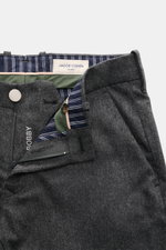 Close-up front top view of Jacob Cohen Wool Trousers 'Bobby' Dark Grey Mélange showing slightly elastic wool, soft touch, regular fit, straight cut, zipper, waistband button, and striped inner lining. Precise Italian craftsmanship – that's what the label 