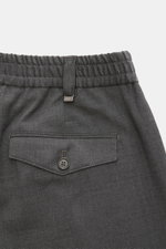 Close-up rear view of PT Torino Trousers 'The Rebel' dark grey mottled, showing button flap back pocket, elastic waistband with belt loop, made from breathable wool and microfibre blend, featuring Rebel Fit, regular thigh width, ankle length, button fly, 