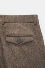 Berwich Merino Wool Pants 'Negroni' brown patterned shown from above, highlighting back flap pocket, belt loops, and herringbone wool fabric.