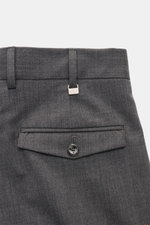 Close-up rear view of PT Torino Wool Pants 'Rebel Fit' dark grey showing waistband, belt loops, back pocket with flap and button, and small metal PT initial, made of elastic virgin wool in a tapered fit with a single waistband pleat and fixed hem cuff.