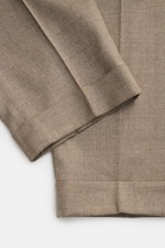 Close-up top-down view of PT Torino Wool Trousers 'Rebel Fit' taupe melange, showcasing soft, stretchy virgin wool fabric and detailed hem cuffs.