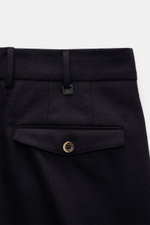 Close-up rear view of PT Torino Wool trousers 'Carrot Fit' dark navy showing elasticated virgin wool fabric, back flap pocket with button, and extended buttoned tab.