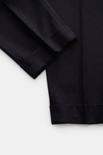 Close-up top-down view of PT Torino Wool trousers 'Carrot Fit' dark navy showing soft virgin wool fabric, fixed hem turn-up, and stitching details. Classic elegance with a modern twist: short cut, stylish double pleats, extended buttoned tab, small watch 