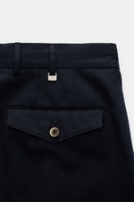 Close-up rear view of PT Torino Pants 'Carrot Fit' navy showing twill structure, back flap pocket with button, belt loops, and metal PT logo tab.