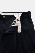 Close-up front view of PT Torino Pants 'Carrot Fit' navy showing mix of cotton and virgin wool, twill structure, zipper, waistband buttons, and extended button tab.