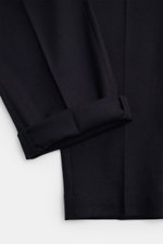 Close-up top-down view of PT Torino Wool Pants 'The Rebel' navy, showcasing elastic virgin wool-cashmere flannel, soft touch, rebel fit, tapered ankle-length legs with neat hems. Comfort and style for the cool season: PT TORINO's 'The Rebel' pants impress