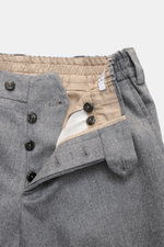 Close-up front view of PT Torino Wool Pants 'The Rebel' grey melange showing button fly, elastic waistband, and soft virgin wool and cashmere flannel. Comfort and style for the cool season: PT TORINO's 'The Rebel' pants impress with an elastic flannel mad
