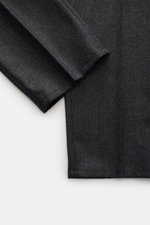 Close-up of Brunello Cucinelli Wool pants 'Italian Fit' dark grey melange, showing fabric texture and hem from top-down perspective.