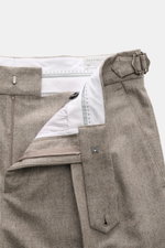 Close-up front view of Brunello Cucinelli Wool Pants Taupe Melange, showing zipper, waistband button, side adjuster, double pleats, and small watch pocket, made of pure virgin wool with a soft touch, regular fit, slightly tapered, French pockets, and back