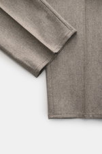 Close-up top view of Brunello Cucinelli Wool Pants Taupe Melange showing soft virgin wool fabric, double pleats, and clean hem detail.