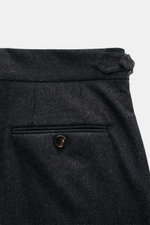 Close-up from the back of Brunello Cucinelli Wool Pants anthracite Melange showing buttoned back pocket, double pleats, side adjuster, and small watch pocket with flap. Cult piece in Italian luxury design: These elegant wool pants with double pleats at th