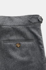 Brunello Cucinelli Wool Pants Grey Melange shown from a close-up side-back angle, featuring pure virgin wool, soft touch, regular fit, slightly tapered legs, zipper and waistband button, double pleats at waistband, French pockets, small watch pocket with 