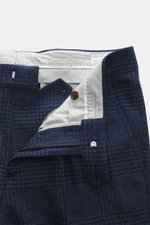 Brunello Cucinelli Wool trousers dark blue/black checked, close-up from above showing waistband, zipper, button, and fabric texture; these trousers by the luxury label BRUNELLO CUCINELLI are a true classic with their pleated front and elegant Prince-of-Wa