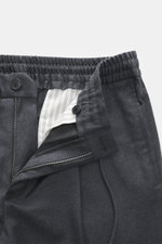 Incotex Woll-Jogpants dunkelgrau meliert, Nahaufnahme von oben, Reißverschluss offen, reine Schurwolle, weicher Griff, Regular Fit, leicht schmal zulaufend, Reißverschluss und Bundknopf, elastischer Bund mit Tunnelzug, Taschen in der Seitennaht, Gesäßtasc