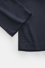 Close-up view of Percival Trousers 'Stanley Herringbone' dark blue fabric, showing classic herringbone weave, soft touch mix of microfiber, wool, viscose, slightly elastic quality, tapered fit, regular thigh width, ankle-length, single waistband pleat, zi