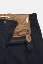 Close-up, top-down view of Briglia 1949 Wool trousers 'Margutta' navy showing zipper, waistband button, single waistband pleat, French pockets, small watch pocket, piped back pockets with one button, regular fit, slightly tapered, flannel made of pure new
