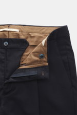 Close-up front view of Briglia 1949 Wool pants 'Tiberios' navy showing twill pure new wool, slightly elastic, soft feel, tapered fit, regular thigh width, ankle length, very narrow tapering, zipper and waistband buttons, simple waistband pleat, French poc