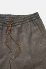 Close-up front view of Briglia 1949 Wool Jogpants 'Wimbledon' grey/brown melange showing elastic waistband with brown drawstring, zip fly, single front pleat, and soft pure wool fabric with lightweight, tapered fit and French pockets, designed for high we